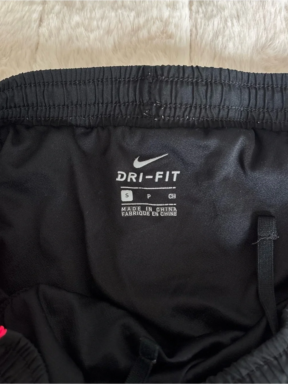 Nike Dri-Fit black shorts with pink/white side panels